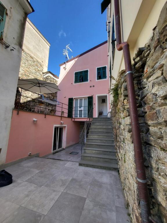 a stone building with a staircase leading up to it at Residenza Solferino in Corniglia