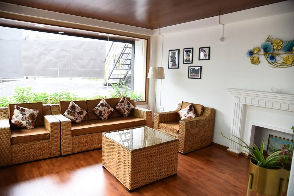 a living room with a couch and a fireplace at PHIBHA VILLA in Shillong