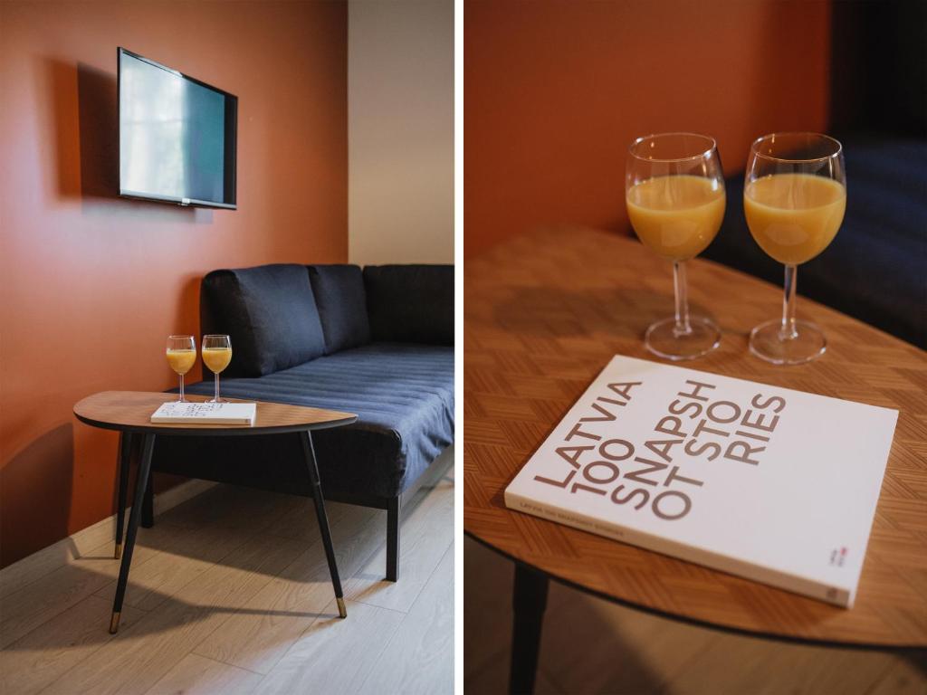 two pictures of a room with a table and two glasses of wine at Rozenstein design apartment in Brocēni