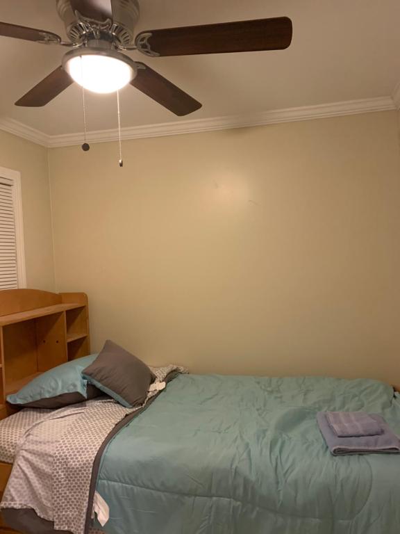 a bedroom with a bed and a ceiling fan at Sky Fresh Home Stay in Apple Valley