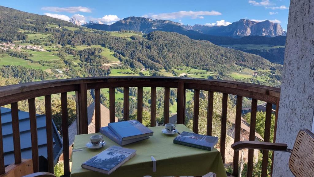 a table on a balcony with a view of mountains at Dolomiten View - South Tyrol in Villandro
