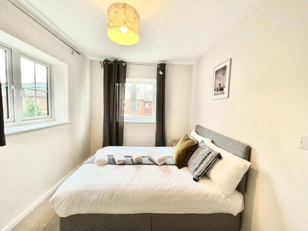 a small bedroom with a bed and a window at 3 bedroom lovely apartment in Slough with free parking in Farnham Royal