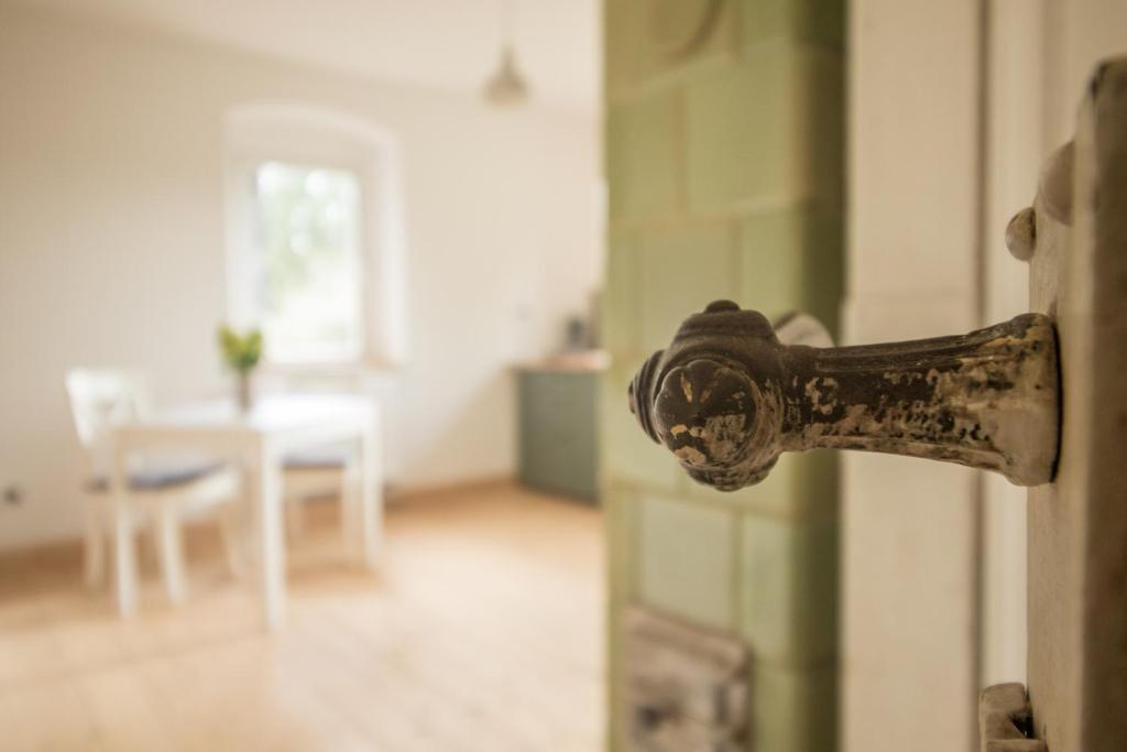 eine offene Tür mit rostigem Türknauf in der Unterkunft Ferienwohnung Schwalbennest in Kiebitz
