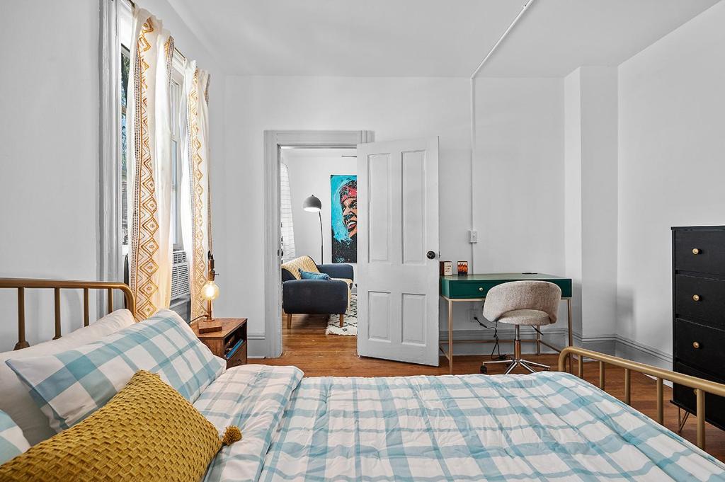 a bedroom with a bed and a desk at Center of Little Italy #1 in Cleveland