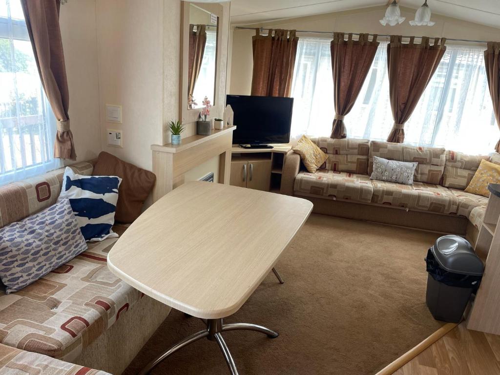 a living room with a table and a couch at G10 Hoburne Devon Bay pet friendly in Goodrington