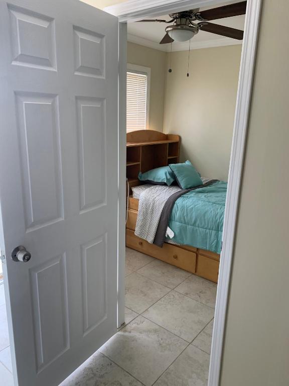 a bedroom with a bed and a door with a mirror at Sky Fresh Home Stay in Apple Valley