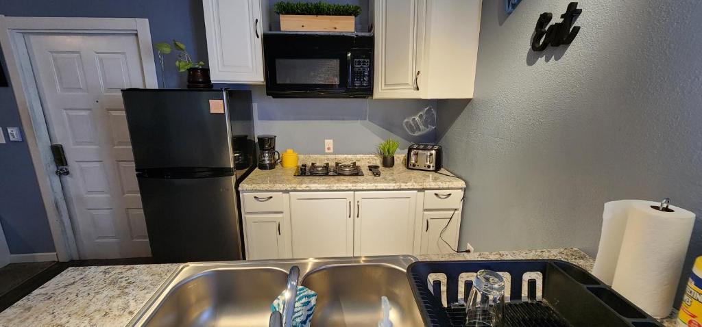 a small kitchen with a sink and a refrigerator at Dolan Springs, Grand Canyon Skywalk in Dolan Springs