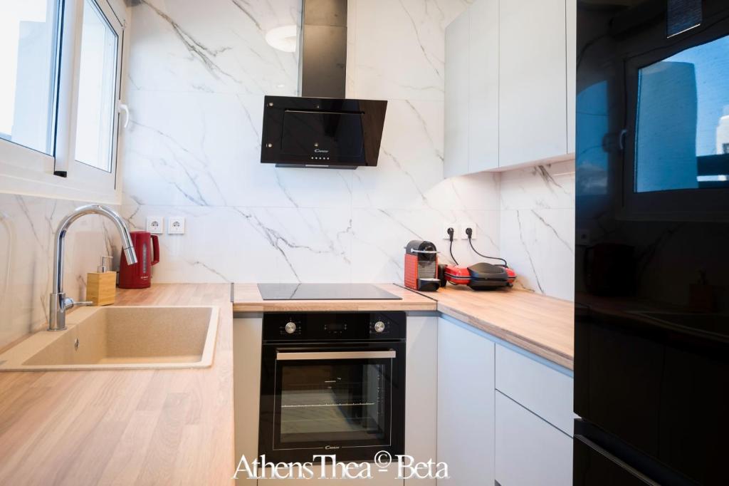 A kitchen or kitchenette at AthensThea Beta Luxury Penthouse Apt in Omonia