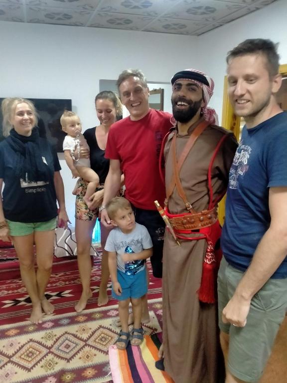 a group of people posing for a picture with a child at Ameer apartment in Wadi Musa