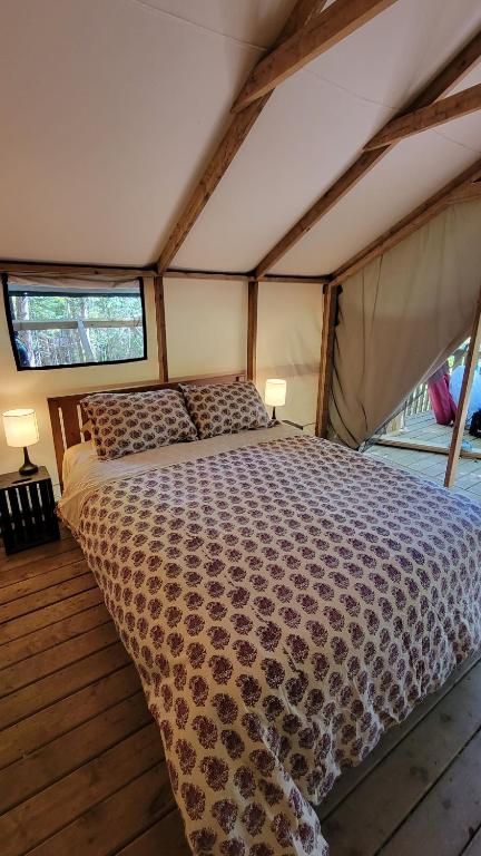 ein Schlafzimmer mit einem Bett in einem Zelt in der Unterkunft Dwight Riverside Inn in Dwight