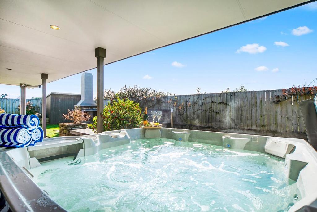 a hot tub in the backyard of a house at The Grand @ Taupo in Taupo