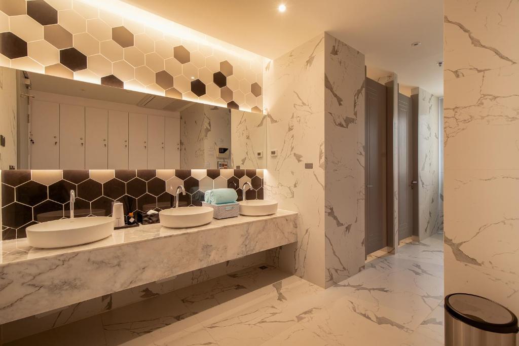 a bathroom with two sinks and a mirror at Thaya Hotel Bangkok in Bangkok