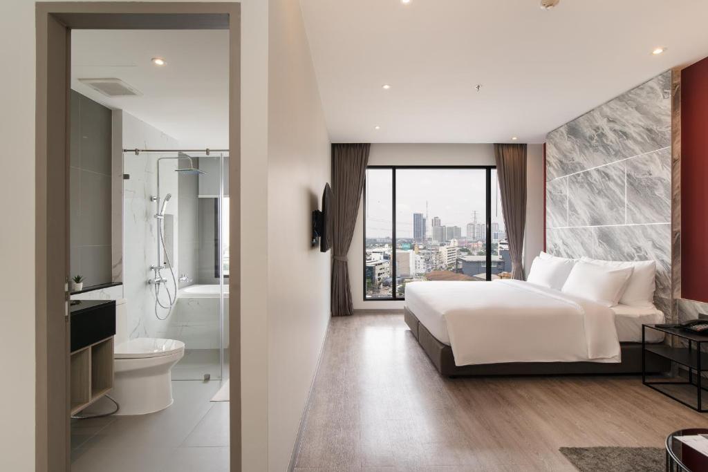 Postel nebo postele na pokoji v ubytování Thaya Hotel Bangkok