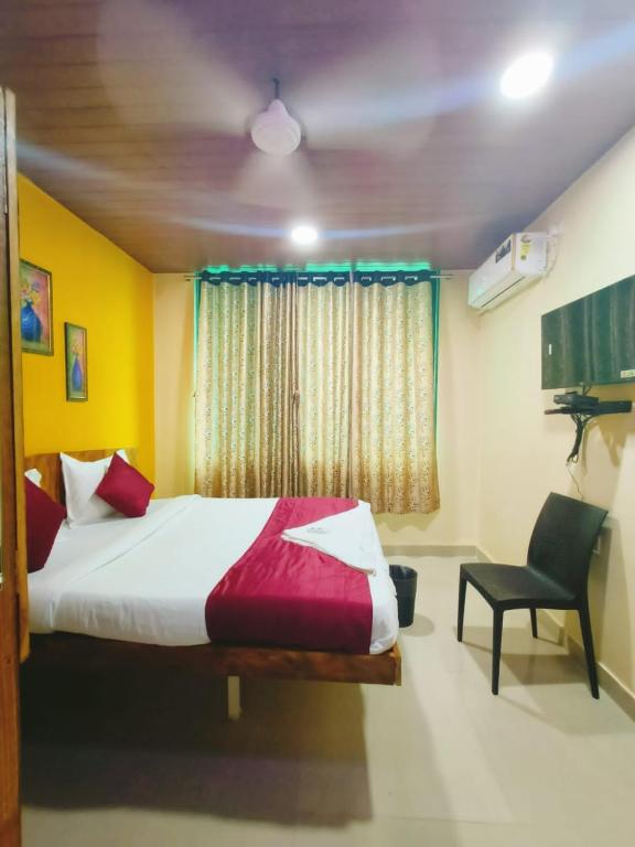 a bedroom with a bed and a chair and a window at sonai POWERED BY PEACEFUL STUDIO in Panvel