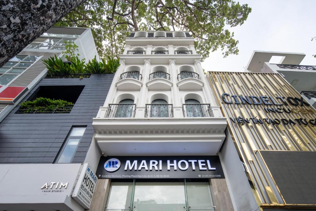 a building with a marriott hotel sign in front of it at Mari Hotel By Connek in Ho Chi Minh City