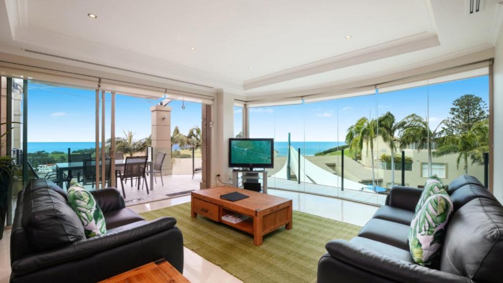 a living room with a view of the ocean at Unit 13 - 3 Bedroom Ocean View in Terrigal