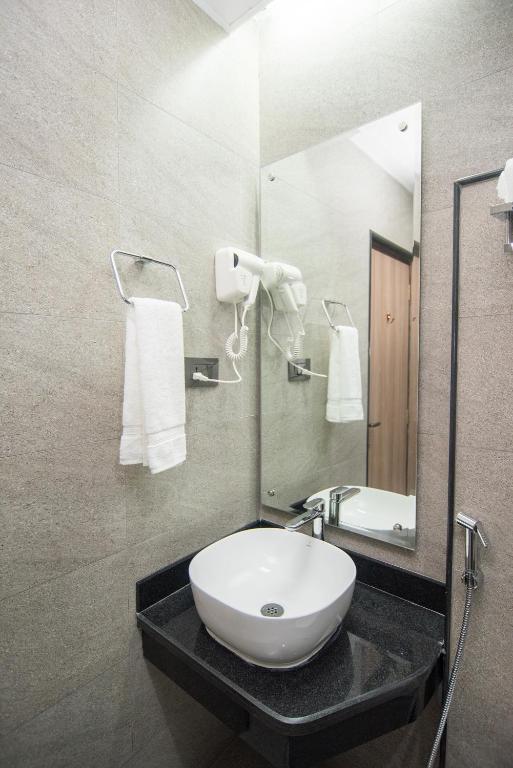 a bathroom with a white sink and a mirror at Everest Boutique Hotel in Kathmandu