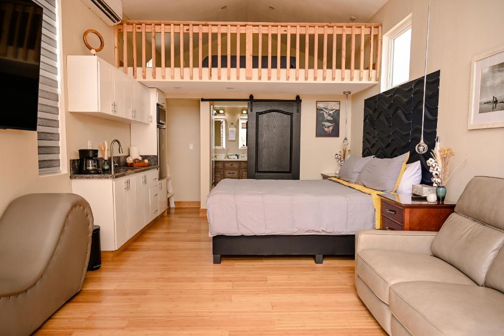 a small bedroom with a bed and a couch at Ariels Paraiso- Ocean view in Primo Tapia