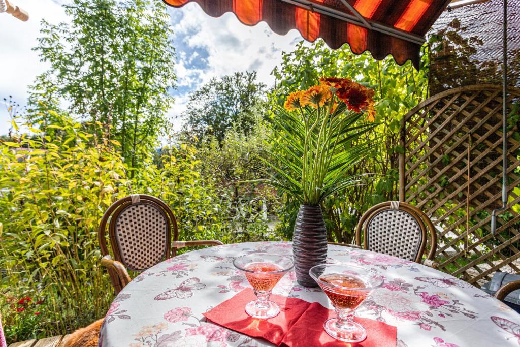 a table with a vase of flowers on it at Ferienwohnung Chiemgau - erleben in Siegsdorf