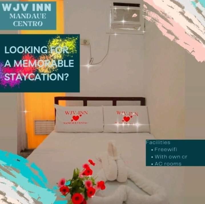 Postel nebo postele na pokoji v ubytování WJV INN Mandaue Centro