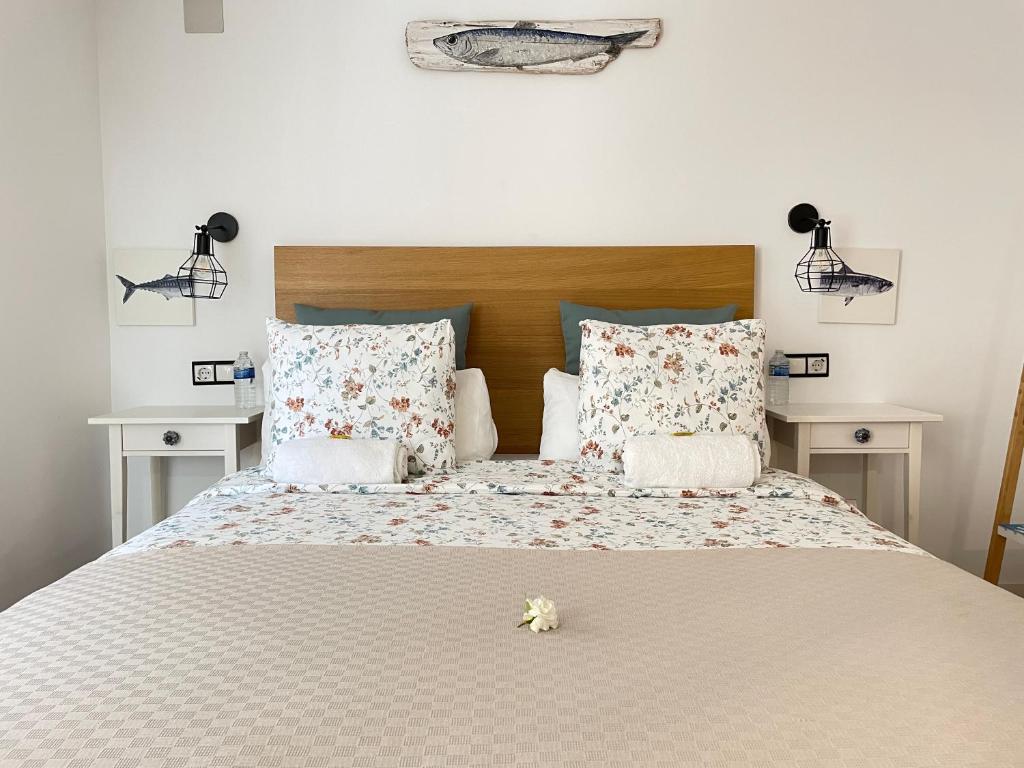 a bedroom with a large bed with flowers on it at Bertoko Urdaibai II in Bermeo