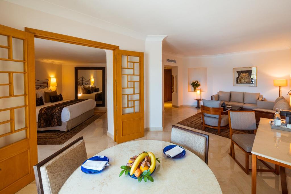 a living room with a bed and a room with a table at The Residence Tunis in Gammarth