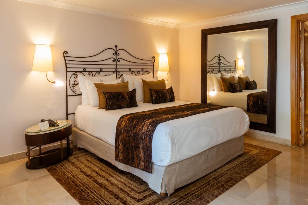 a bedroom with a large bed and a large mirror at The Residence Tunis in Gammarth
