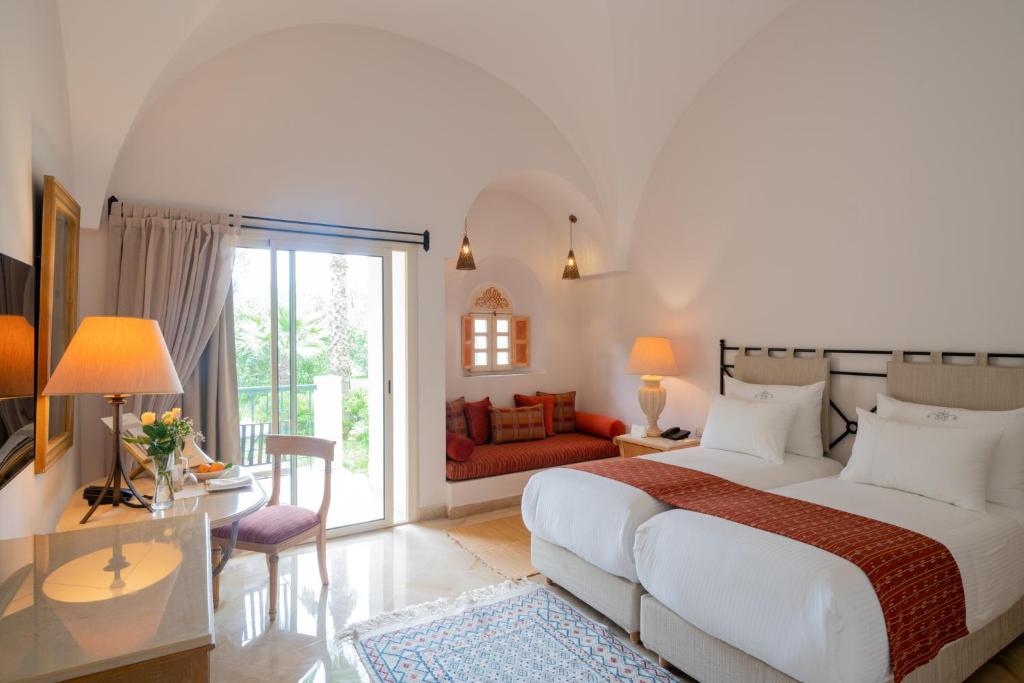 a bedroom with a bed and a living room at The Residence Tunis in Gammarth