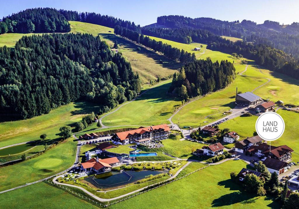 an aerial view of a house on a golf course at Haubers Naturresort Landhaus in Oberstaufen