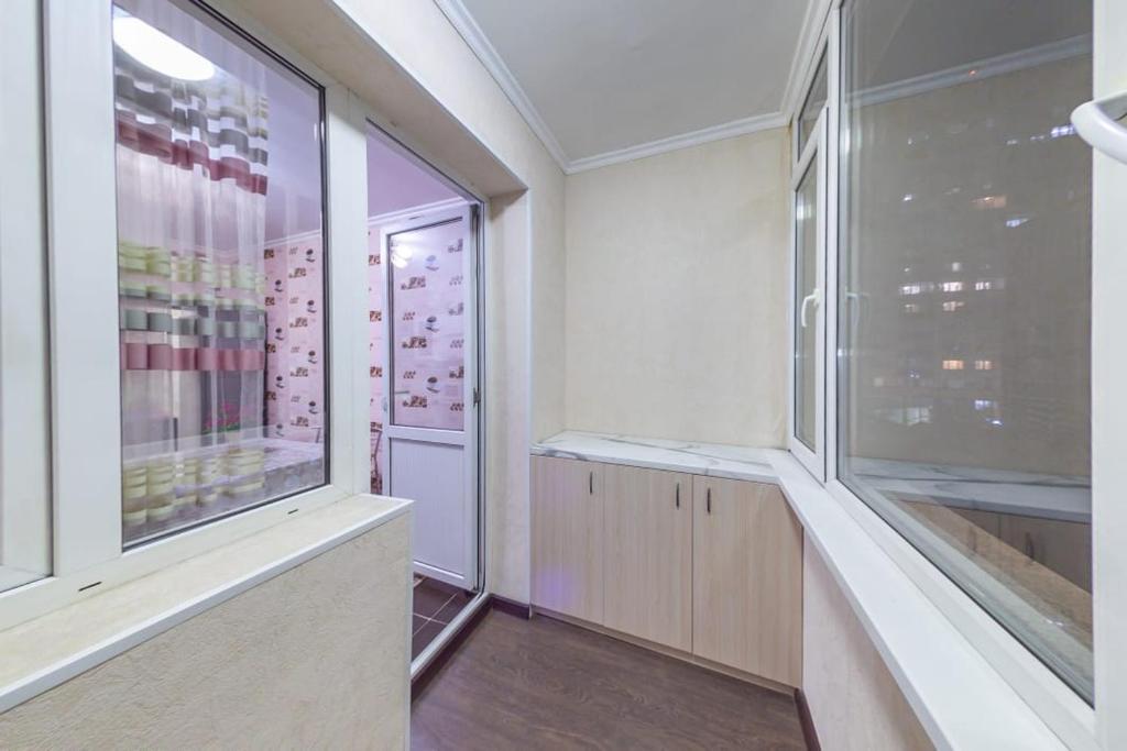 una cocina con una ventana grande y un farmacéutico cistático en Просторная квартира в жк Науаи около ТРЦ МЕГА, en Almaty