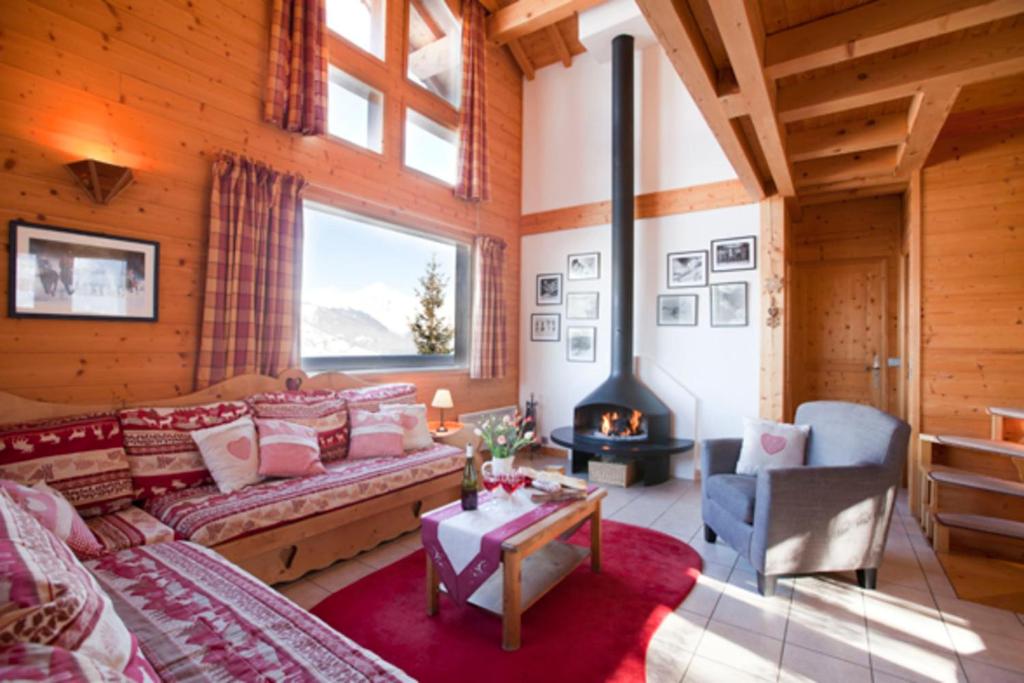 a living room with a couch and a fireplace at Chalet Juliet 10 people in Montalbert