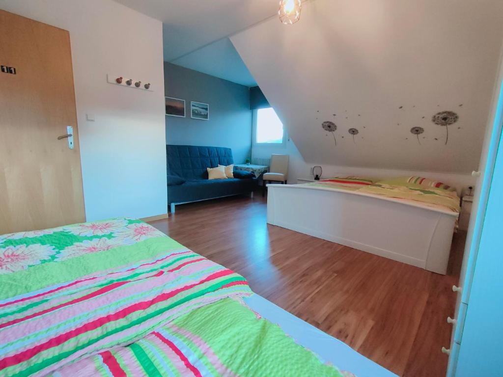 a bedroom with a bed and a living room at Pension Sauerland in Winterberg