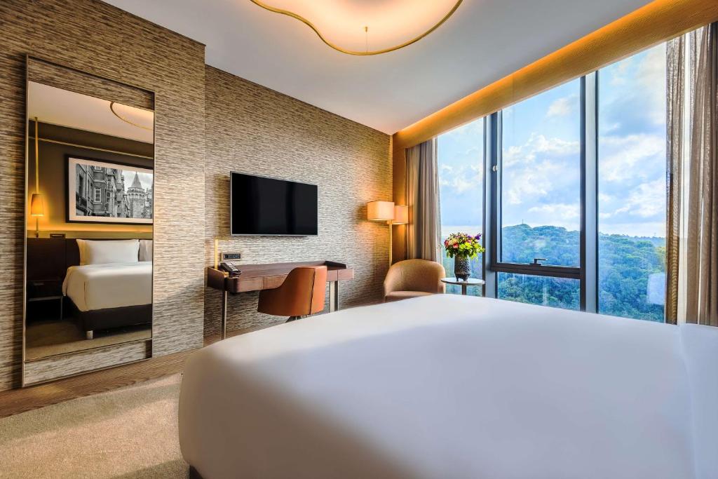 a hotel room with a bed and a large window at Radisson Collection Hotel, Vadistanbul in Istanbul