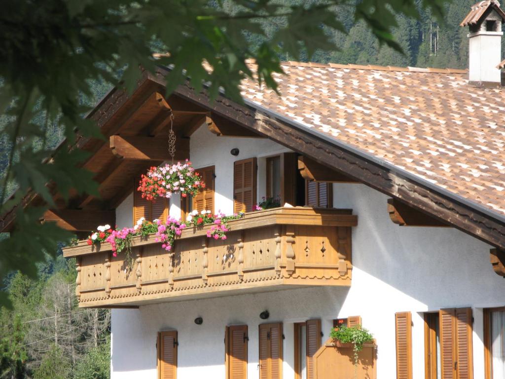 a building with a balcony with flowers on it at Casa Mavignola in Madonna di Campiglio