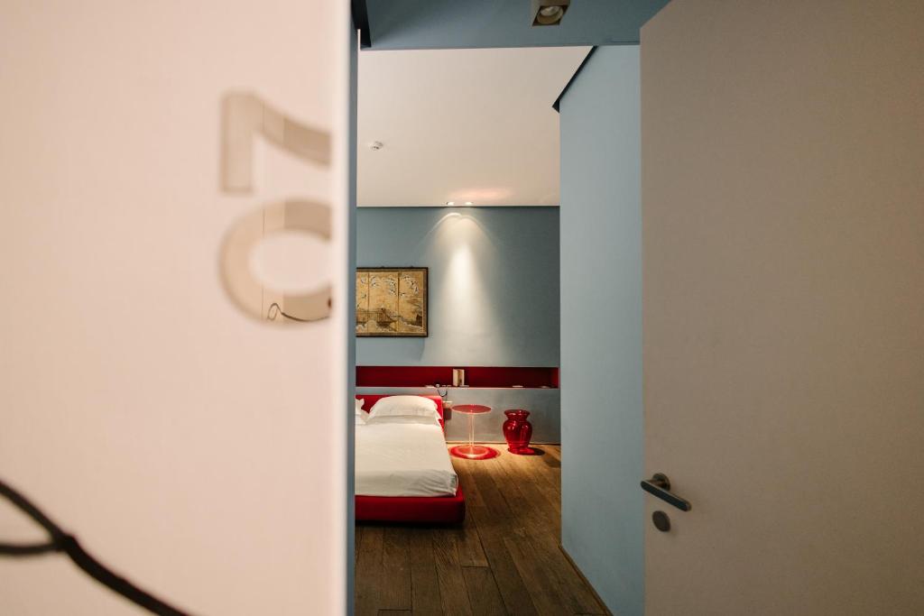 a room with a bed and a door to a bedroom at Palazzo Segreti in Milan