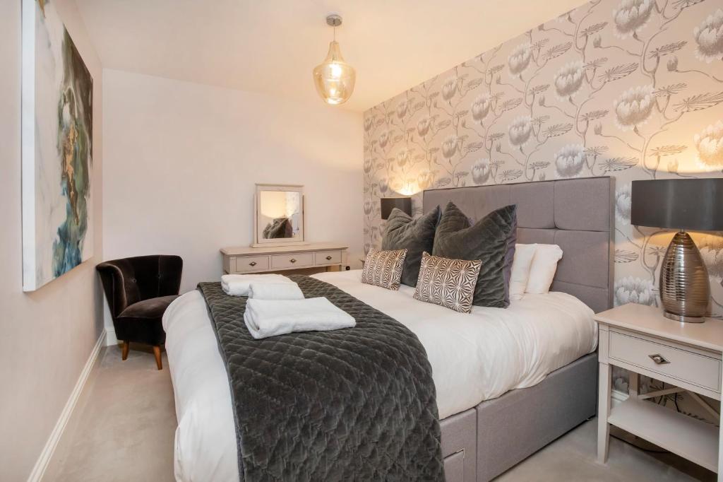 a bedroom with a large bed and a desk at 8 Blue Bridge- Elegant and Luxurious 1 Bedroom Apt- Free Parking in York