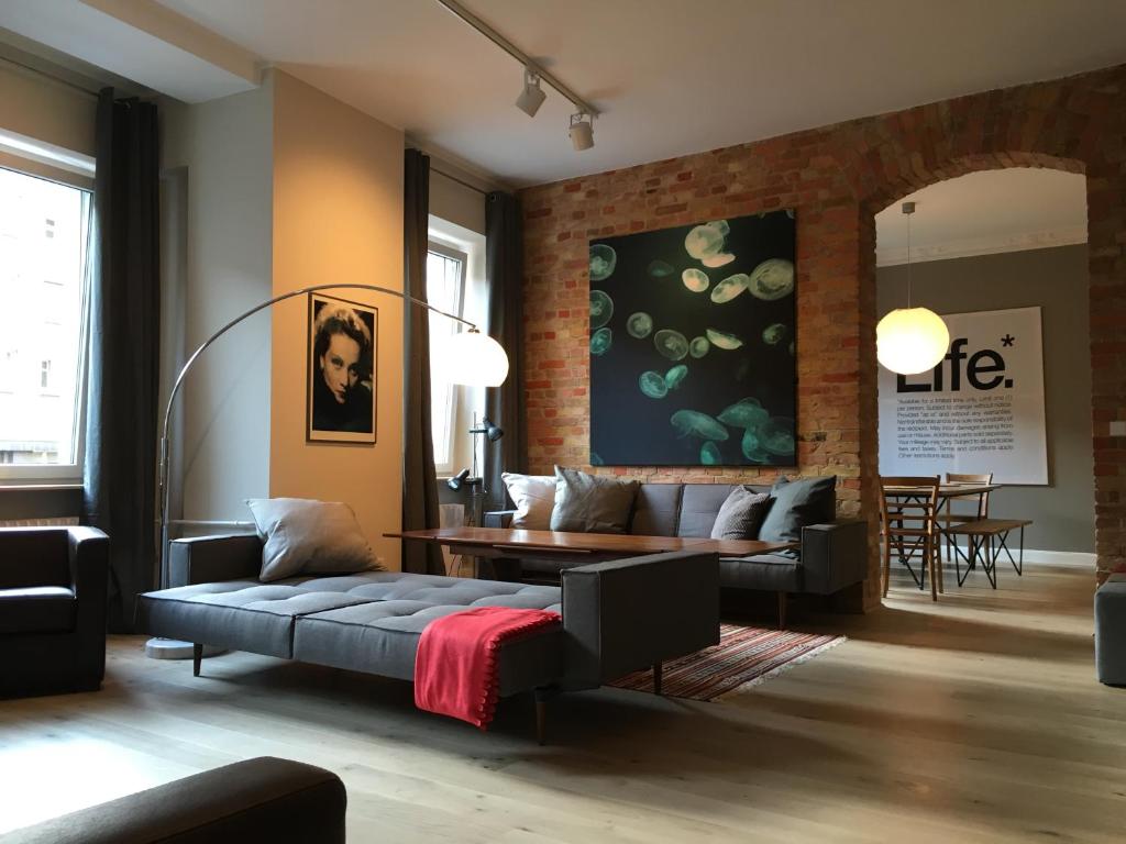 a living room with a couch and a table at Berlin Style Apartments in Berlin