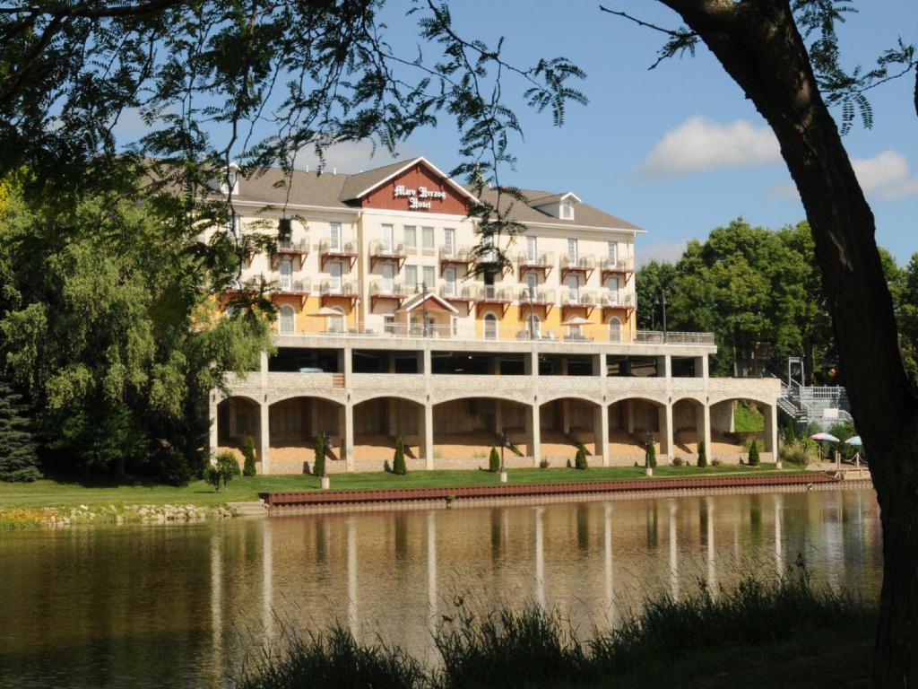 a large building next to a body of water at Marv Herzog Hotel in Frankenmuth