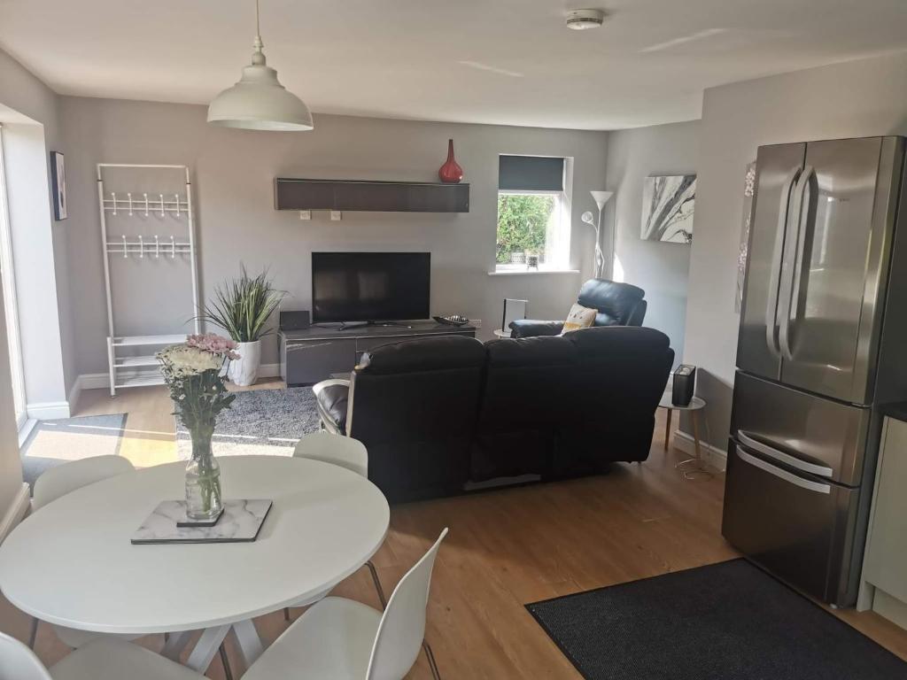 a living room with a black couch and a table at Green Street Retreat in York