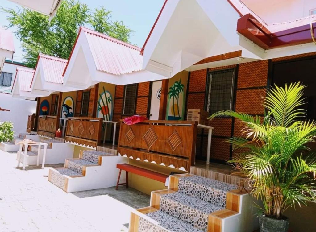 a row of benches outside of a building at Sandstorm Lodge and Cafe in Puerto Galera