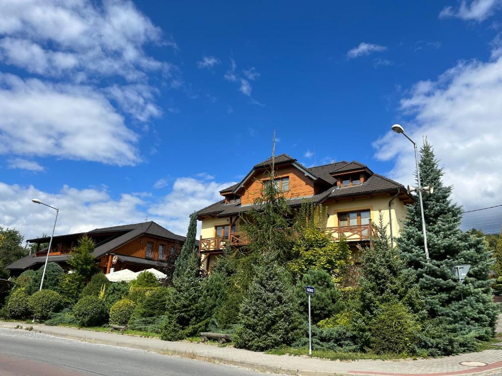 a house sitting on the side of a road at Apartments Hážovský Dvůr in Rožnov pod Radhoštěm