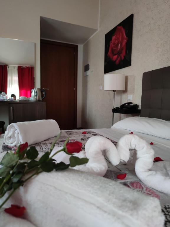 Posteľ alebo postele v izbe v ubytovaní Le Undici Rose Hotel