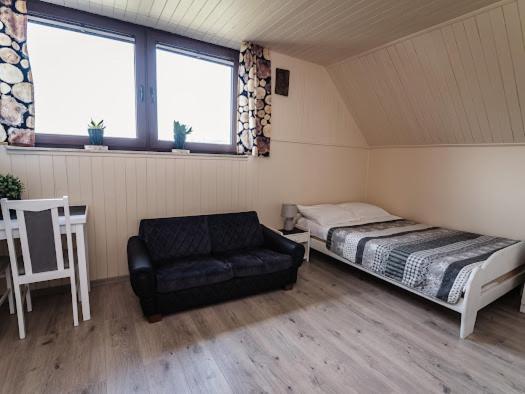 Posteľ alebo postele v izbe v ubytovaní Apartamenty na wzgórzu