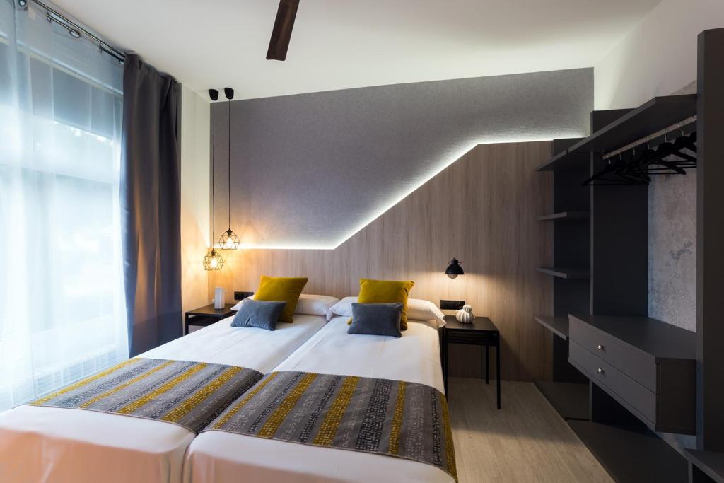 Postel nebo postele na pokoji v ubytování Hotel Onyarbi