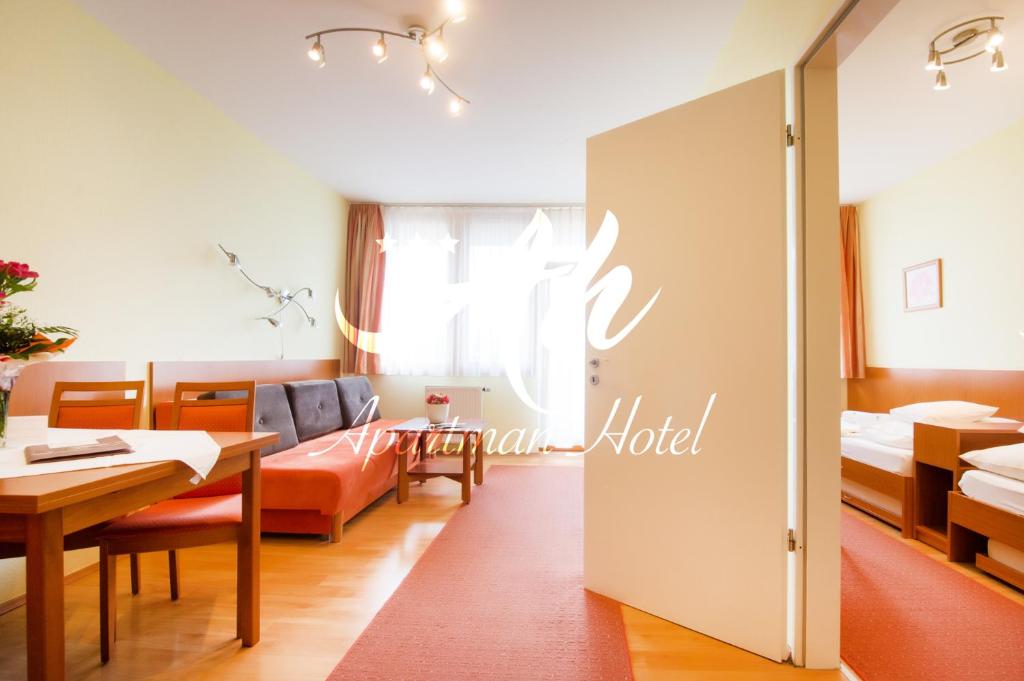 Łóżko lub łóżka w pokoju w obiekcie Apartman Hotel