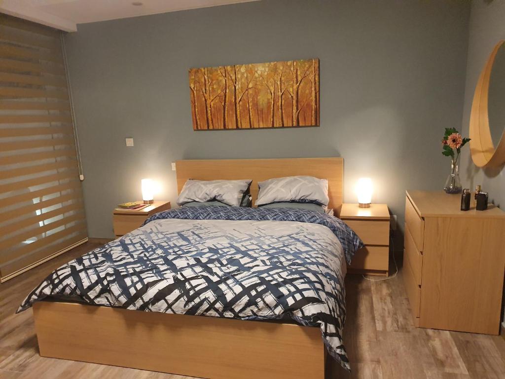a bedroom with a bed with two night stands and two lamps at Seven in Sliema