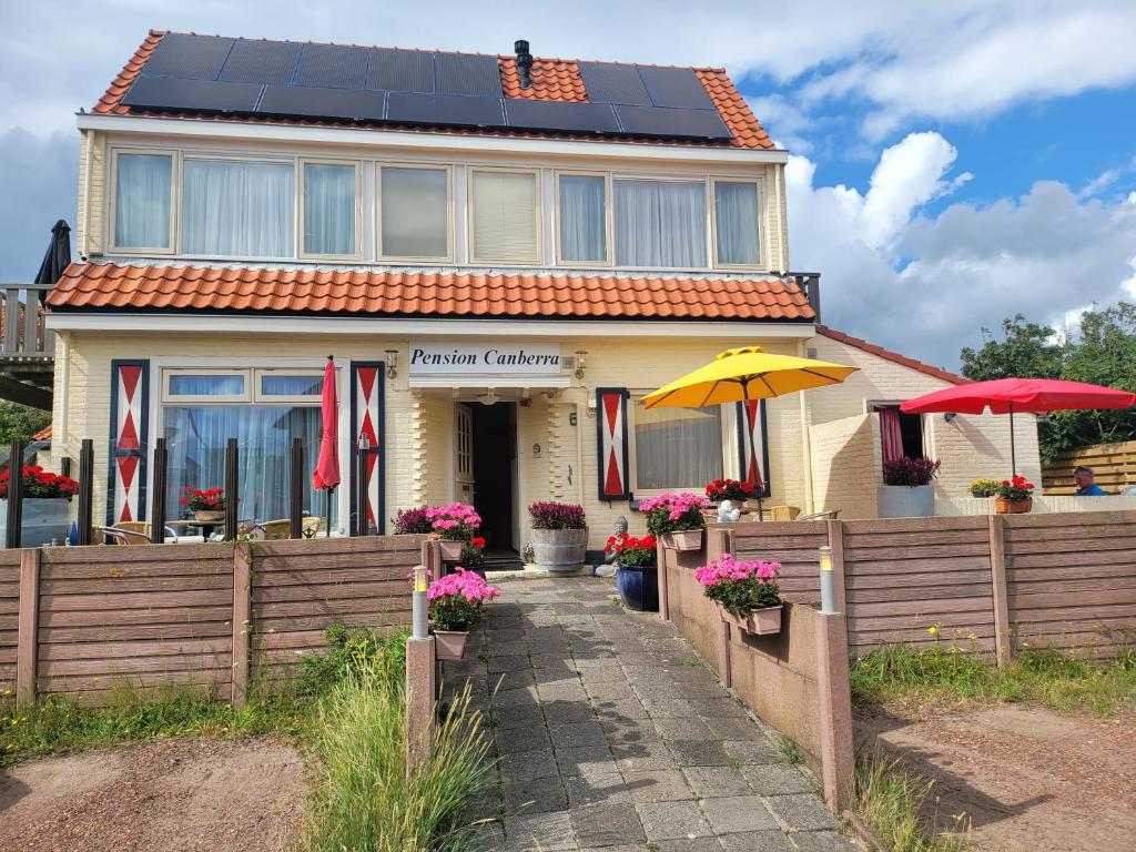 a house with solar panels on the roof at Pension Canberra in Bergen aan Zee