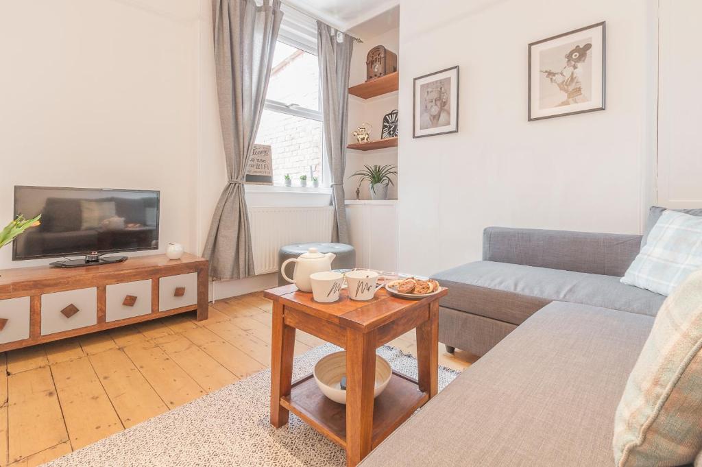 a living room with a couch and a table at Chestnut House Exeter in Exeter