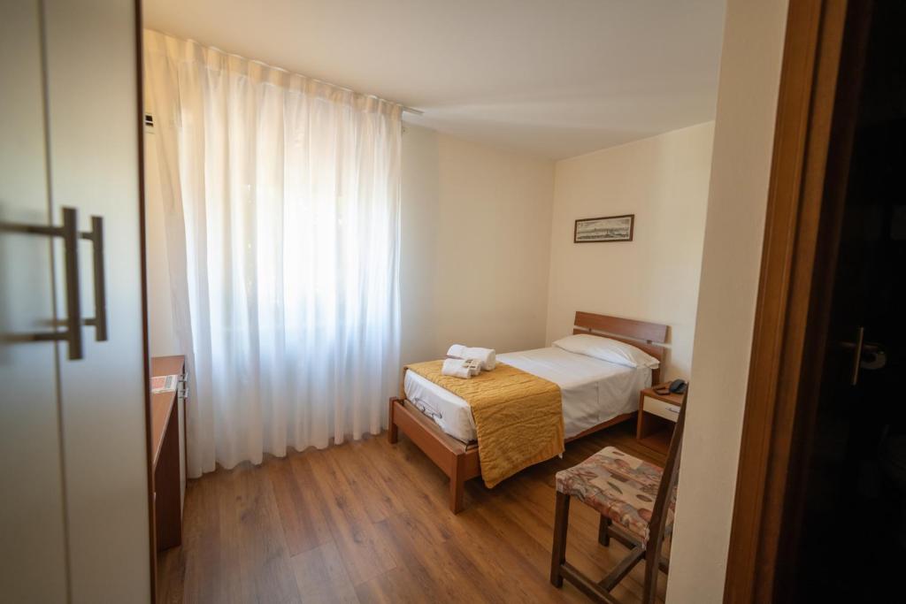 Postel nebo postele na pokoji v ubytování Hotel Siros