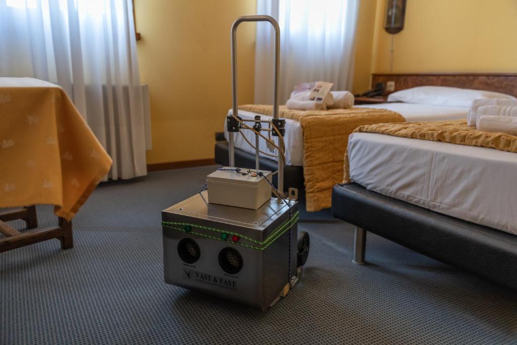 Postel nebo postele na pokoji v ubytování Hotel Siros